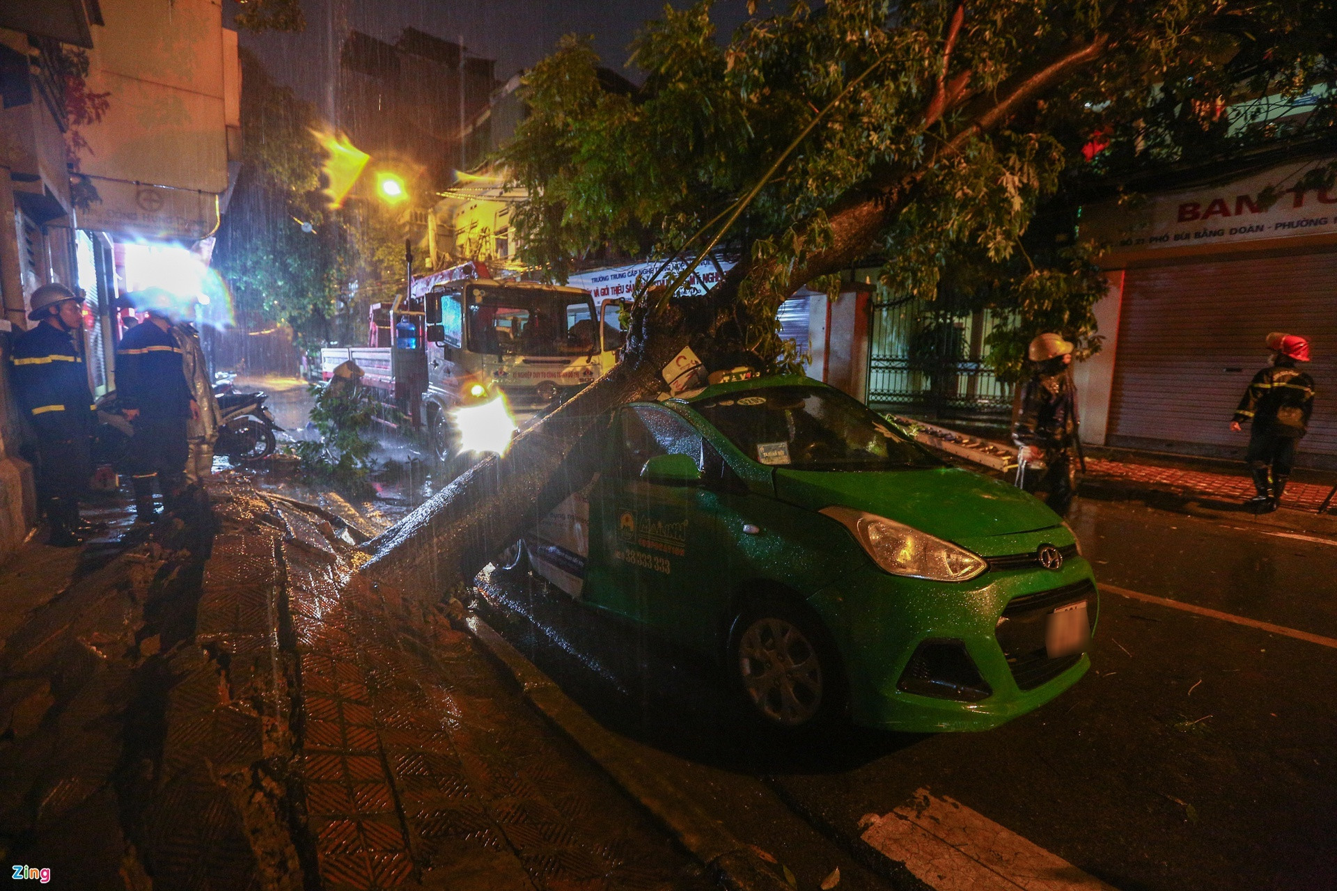 Hà Nội: Cây đổ đè bẹp xe taxi trong mưa lớn - 1