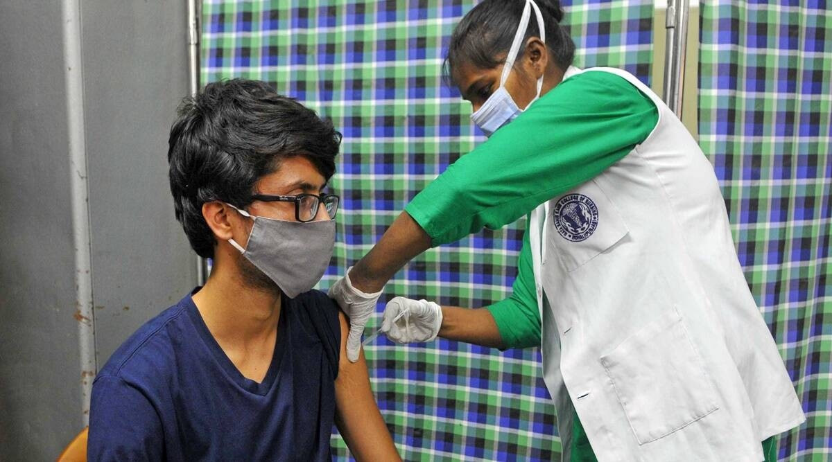 A young beneficiary gets Covid-19 vaccine at a vaccination centre in Sector 45 of Chandigarh. (Express Photo by Kamleshwar Singh)