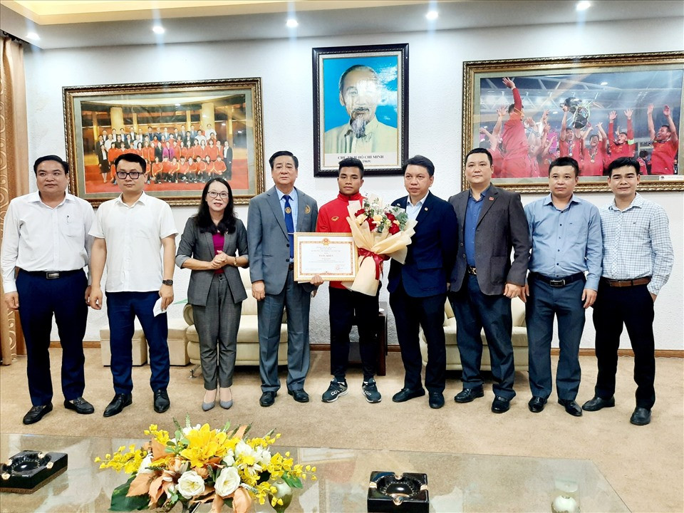 Đại diện lãnh đạo Ủy ban Dân tộc Chính phủ trao bằng khen và phần thưởng cho cầu thủ Hồ Thanh Minh. Ảnh: VFF