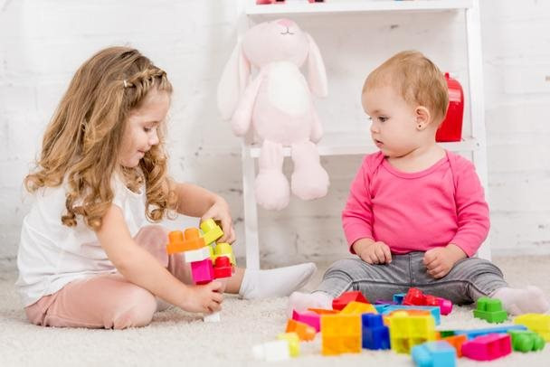 stock-photo-adorable-sisters-playing-constructor-together.jpg