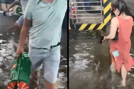 Xách vali, tháo giày lội nước ở sân bay Tân Sơn Nhất sau trận mưa lớn