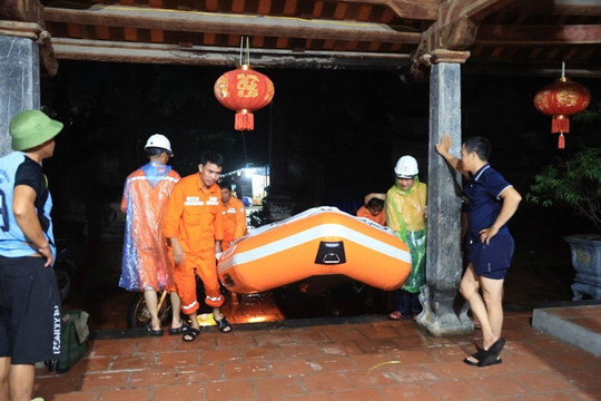 Hanoians rely on each other to navigate through floodwater